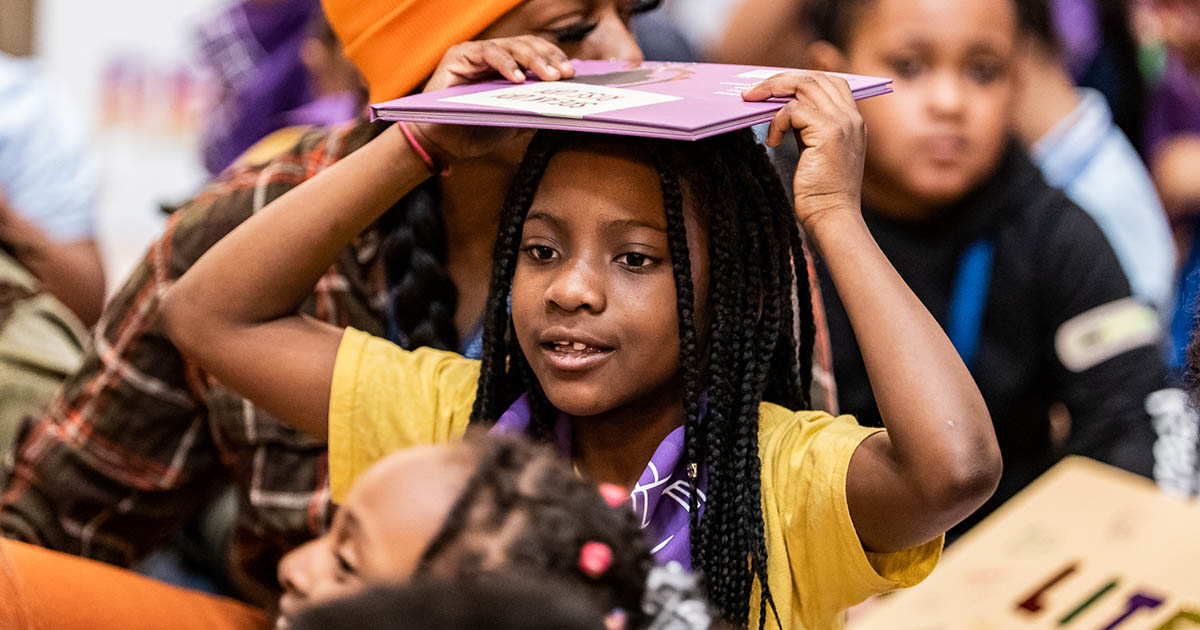 School girl with a book on her head