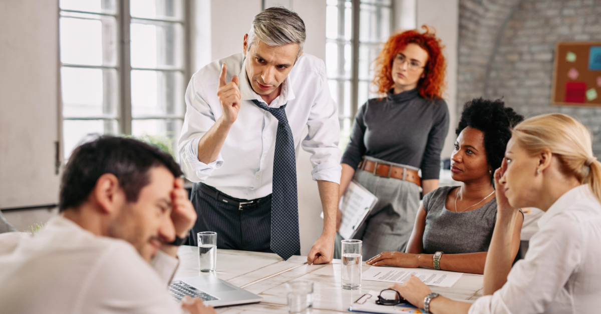 Displeased man arguing with colleagues in a meeting