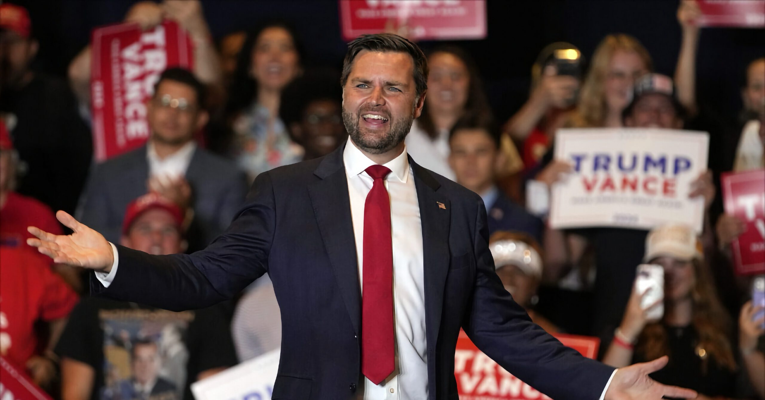 Senator JD Vance speaking to a crowd at a political rally, 2024