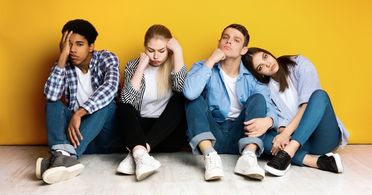 Young Diverse Friends Sitting Together Looking Tired and Bored