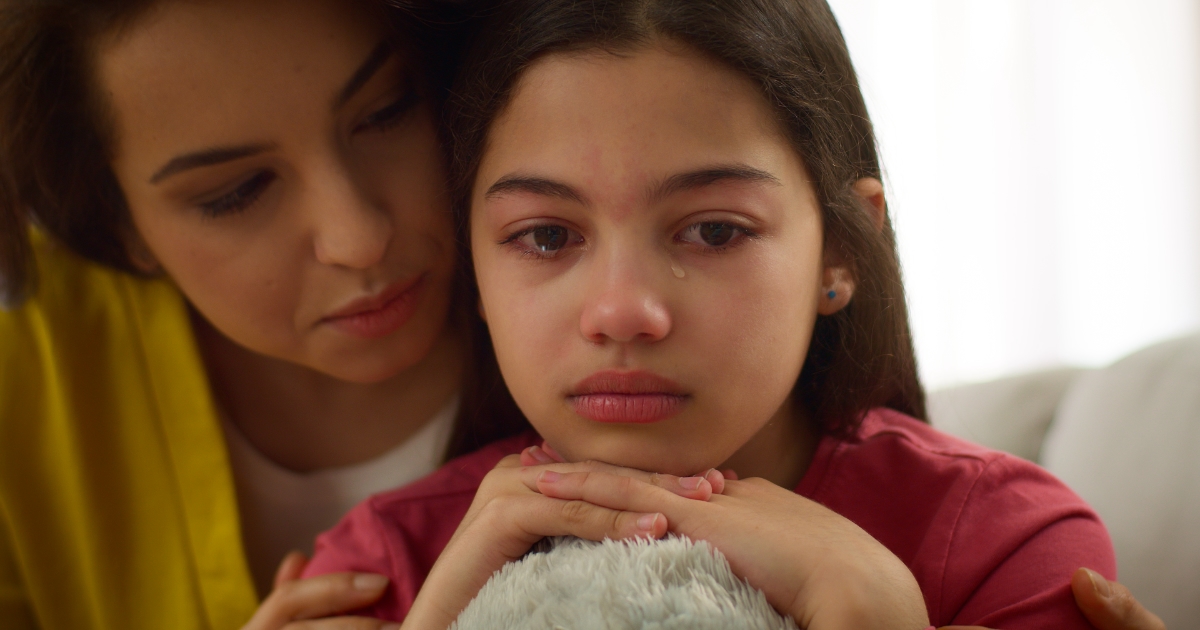 Close up Latina girl crying sad anxious depressed little girl child kid daughter cry upset by school