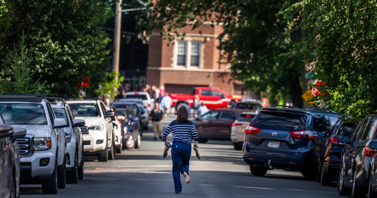 Mother running toward the Annunciation Church Shooting in Minneapolis, looking for her child